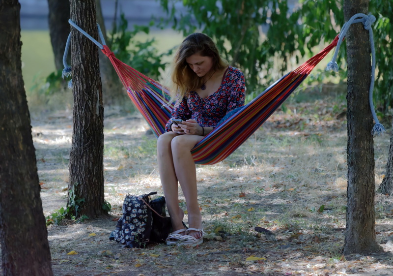 Woman sitting on hammock